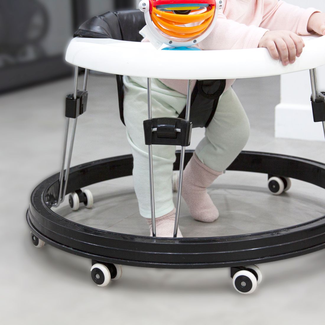 A baby taking first steps in a walker